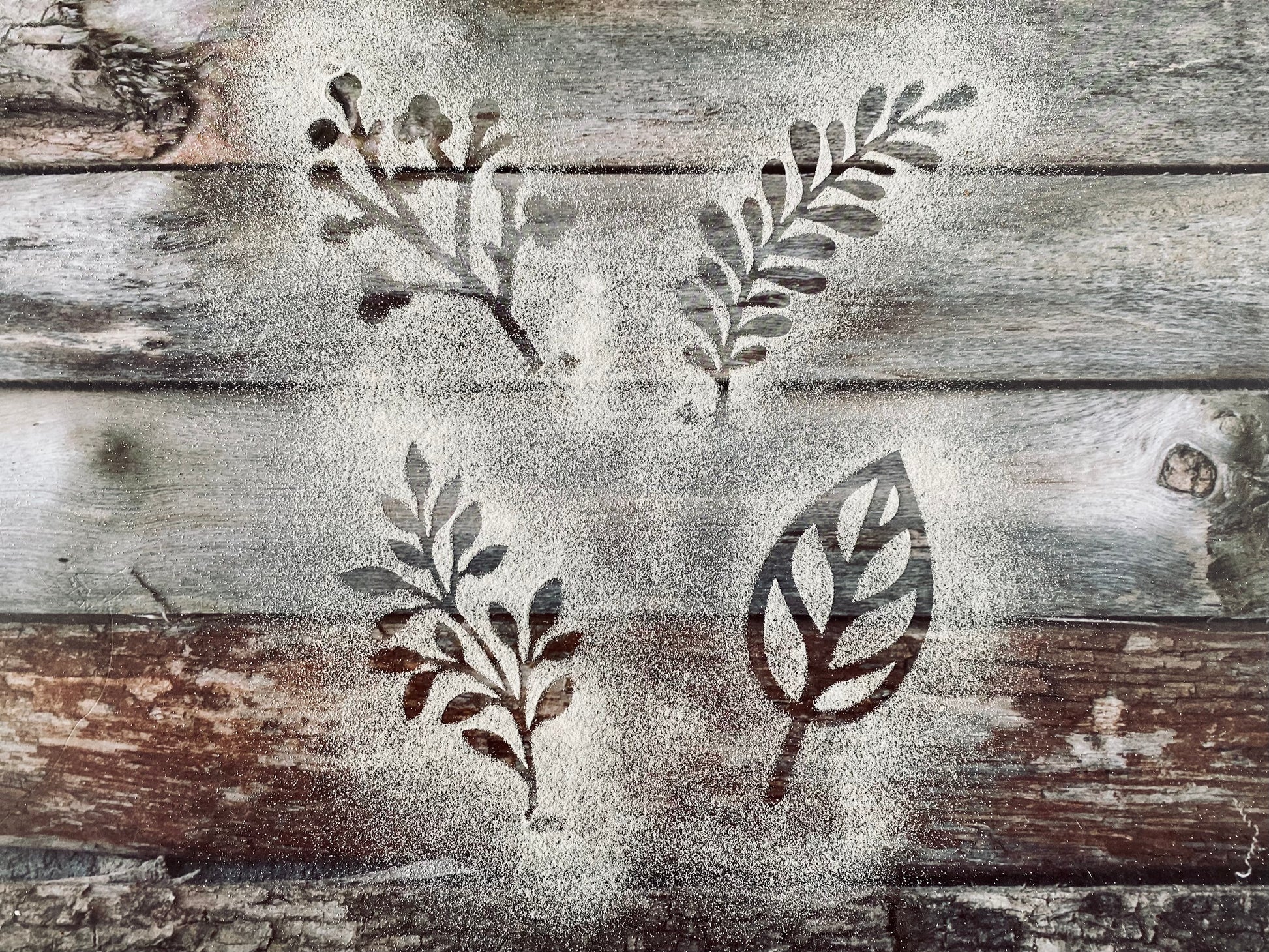 Set of leaf stencils on a wooden surface